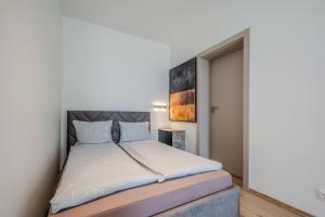 a bedroom with a large bed in a room at Topolių terasos in Palanga