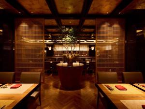 a restaurant with a table with a plant in the middle at The HOTEL SANRAKU KANAZAWA in Kanazawa