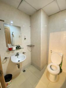 a bathroom with a toilet and a sink at Da nang seaview MT apartment in Danang +9 photos