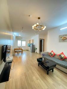 a living room with a couch and a table at Da nang seaview MT apartment in Danang