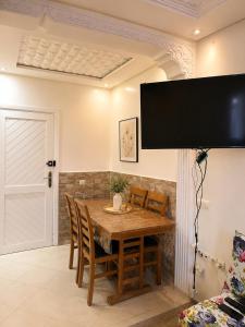a dining room with a wooden table and chairs at Perfect home in Temara