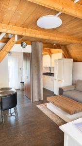 a kitchen and a living room with a table and a refrigerator at Harmónia és Béke Csopak in Csopak
