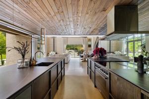 a large kitchen with a large island in a house at Pavilion-Style Residence Queenstown in Queenstown