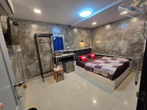 a bedroom with a bed with red pillows on it at BB GuestHouse in Ban Zong Katiam