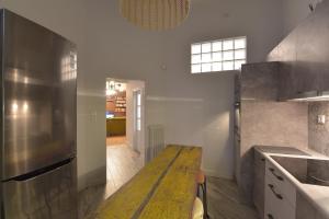 a large kitchen with a wooden table in it at Kolonaki Deco Apartment in Athens +20 photos
