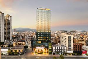 a rendering of a tall building in a city at Four Points by Sheraton Shanwei Lufeng in Shanwei