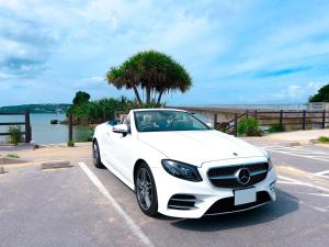 a white car parked in a parking lot at JAPAVISTA Casa De Boss in Naha