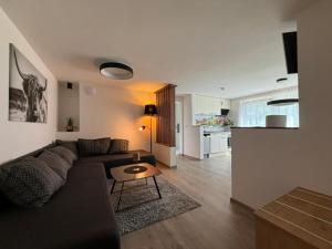 a living room with a couch and a table at Appartements-Pension Lindenheim in Schladming
