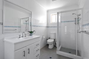 a bathroom with a sink and a shower and a toilet at Foredeck Views in Manyana +39 photos
