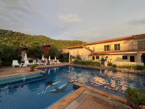 a swimming pool with a person in the water at Poonsap Resort in Ko Lanta