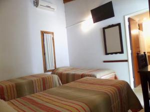 Postel nebo postele na pokoji v ubytování Hotel Carmen de Areco