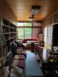 a living room with a couch and a table at スペースigusa専用寝室2室に2名様3泊よりマンスリー割引がおすすめ in Tokyo