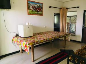 a table with a laptop on top of it in a room at Green View Resort in Ella