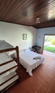 a bedroom with a large bed and a bunk bed at Pousada 4 Elementos Guaruja in Guarujá +62 photos