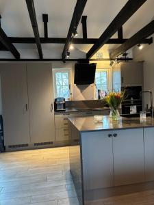 a kitchen with white cabinets and a counter top at Kanalhuset in Tvååker +8 photos