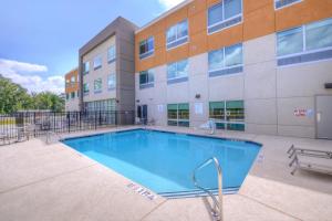 a swimming pool in front of a building at Holiday Inn Express - Bethlehem by IHG in Winder