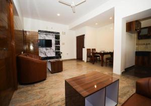 a living room with a couch and a table at AMV Airport Residency in Bangalore