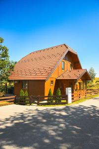 a large wooden house with a brown roof at Vikendica Nina 2 in Zlatibor