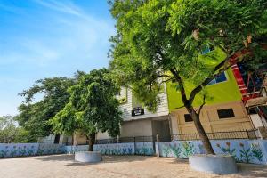 two trees sitting in front of a building at Super Hotel O Gorakhpur Railway Junction Road Golghar Formerly RR Inn in Gorakhpur