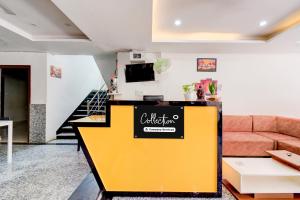 a yellow counter in a living room with a couch at Super Collection O DLF CyberCity Hyderabad Formerly Key Suites in Kondapur