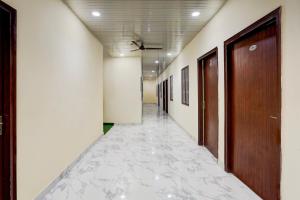 an empty corridor of an office building with a corridorngth at OYO Collection O Govind Vihar Matiyari Formerly Saffron in Lucknow