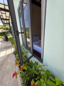 a room with a window with a bed and flowers at Tiffany Villa 2 in Ko Phangan