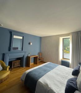 a blue bedroom with a bed and a fireplace at Fleurs de lin in Saint-Brieuc-des-Iffs +50 photos