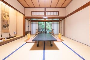 a dining room with a table and chairs at Kutsurogi no yado Kiunsoh in Oda
