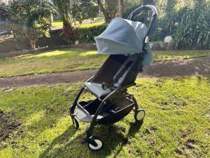a baby stroller sitting in the grass in a yard at warm, quiet and convenient ! in Auckland