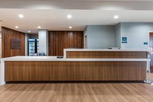 an empty waiting room with a reception counter at MainStay Suites Carlsbad South in Carlsbad