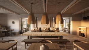 a restaurant with wooden tables and chairs and lights at Parian Chronicle Hotel Paros, Destination by Hyatt in Kampos Paros