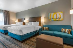 a hotel room with two beds and a couch at MainStay Suites Carlsbad South in Carlsbad +20 photos
