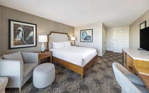 a hotel room with a bed and a tv at Redondo Beach Hotel, Tapestry Collection by Hilton in Redondo Beach