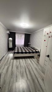 a bedroom with a large bed in the middle of the room at Квартира посуточно in Balqash +2 photos