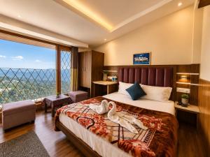a bedroom with a bed with two stuffed animals on it at The Town Boho in Shimla