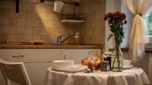 a table with a white table cloth and a vase of flowers at Widokówka Karkonoska in Szklarska Poręba +103 photos
