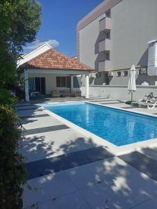 a swimming pool in front of a building at Villa Adriatic 2 in Biograd na Moru