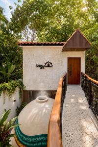 a walkway to a house with a building at Akbal Cancun in Cancún