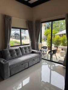a living room with a couch and a table at Tiffany Villa 2 in Ko Phangan +19 photos