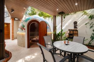 a patio with a table and chairs and a igloo at Akbal Cancun in Cancún