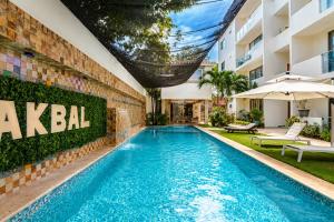 a swimming pool in front of a building at Akbal Cancun in Cancún