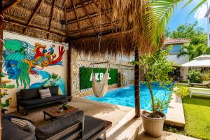 a villa with a hammock and a swimming pool at Akbal Cancun in Cancún +73 photos