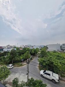 a street with two cars parked in a parking lot at Home Phong Vân in Hâu Thon