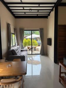 a living room with a couch and a table at Tiffany Villa 2 in Ko Phangan