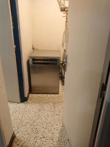 a hallway with a small refrigerator in a room at Maison de village commingeoise in Miramont-de-Comminges