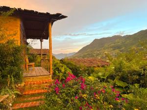 a house with a wooden porch with flowers at SaPa Farmer House in Sapa +173 photos