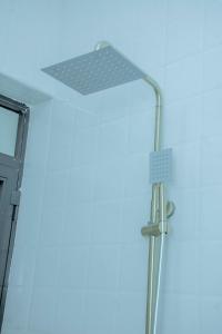 a shower in a bathroom with a blue ceiling at Obama Apartments in Mbweni +15 photos