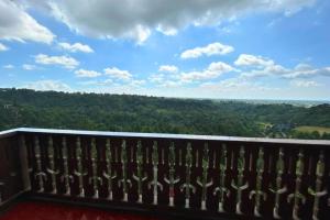 a balcony with a view of the forest at Crosswinds Swiss Deluxe Suite in Tagaytay