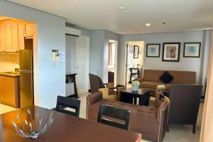 a living room and kitchen with a couch and a table at Crosswinds Swiss Deluxe Suite in Tagaytay +41 photos