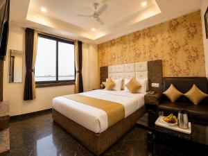 a hotel room with a bed and a window at Hotel Hyfa Continental in Lucknow
